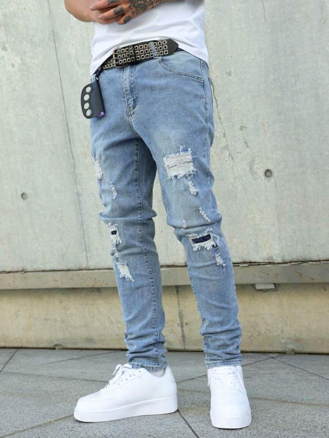 light wash distressed denim jeans with pocket detail
