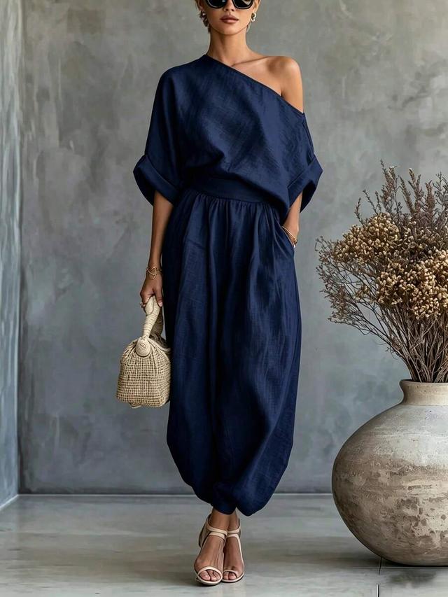 navy blue asymmetrical shoulder top and trousers set