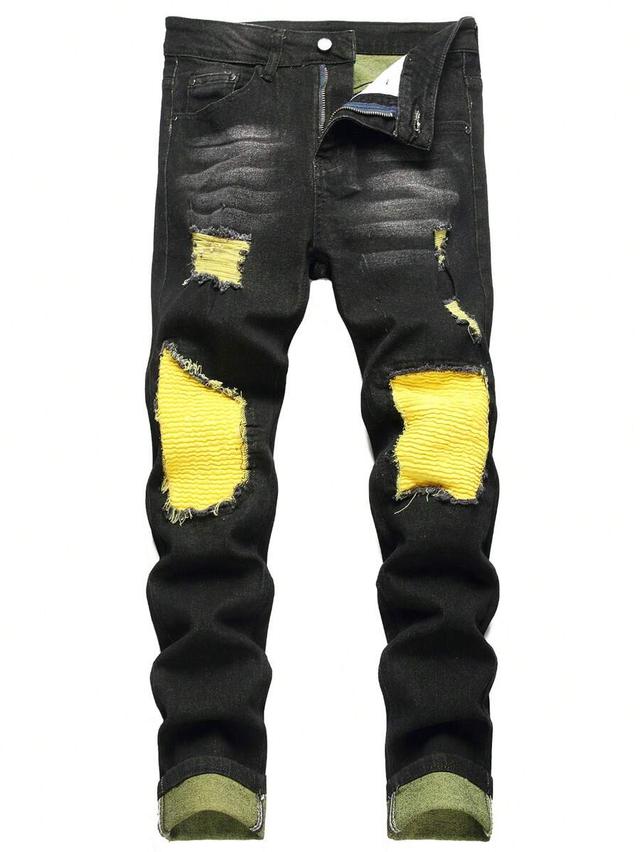 black distressed slim fit jeans with yellow underlay