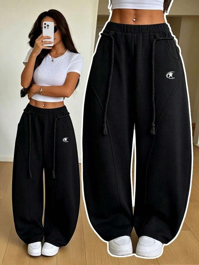black wide leg athleisure sweatpants with curved seam detailing