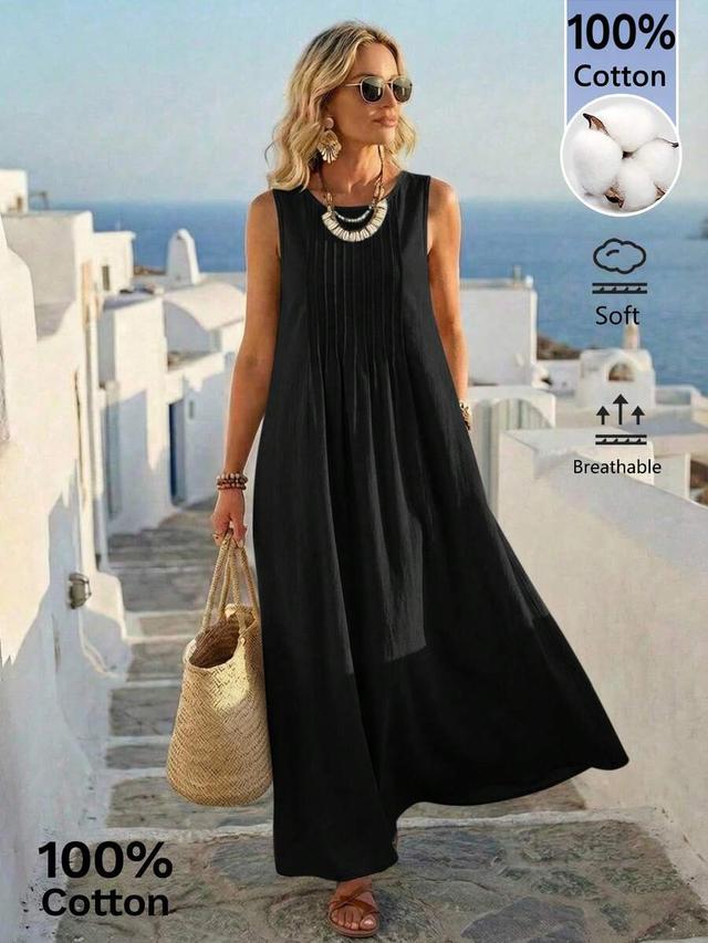 black sleeveless cotton dress with front pleats
