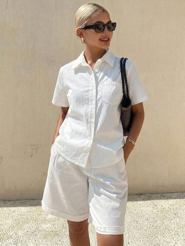 white linen short-sleeve button-up shirt and matching shorts