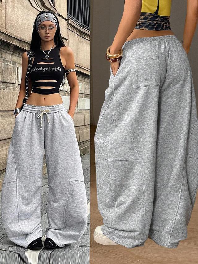 light grey baggy sporty sweatpants with curved hem