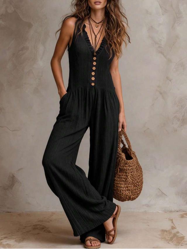 black textured sleeveless jumpsuit with button front