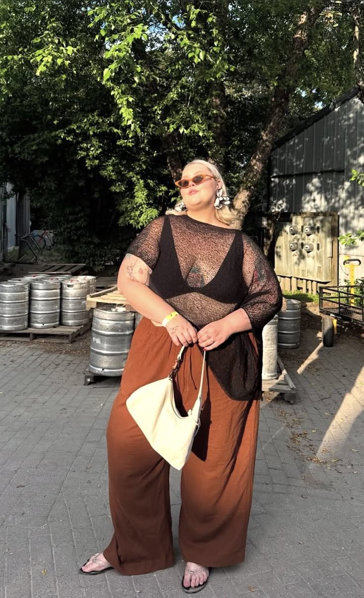 black sheer knit top with black bralette and brown wide-leg trousers