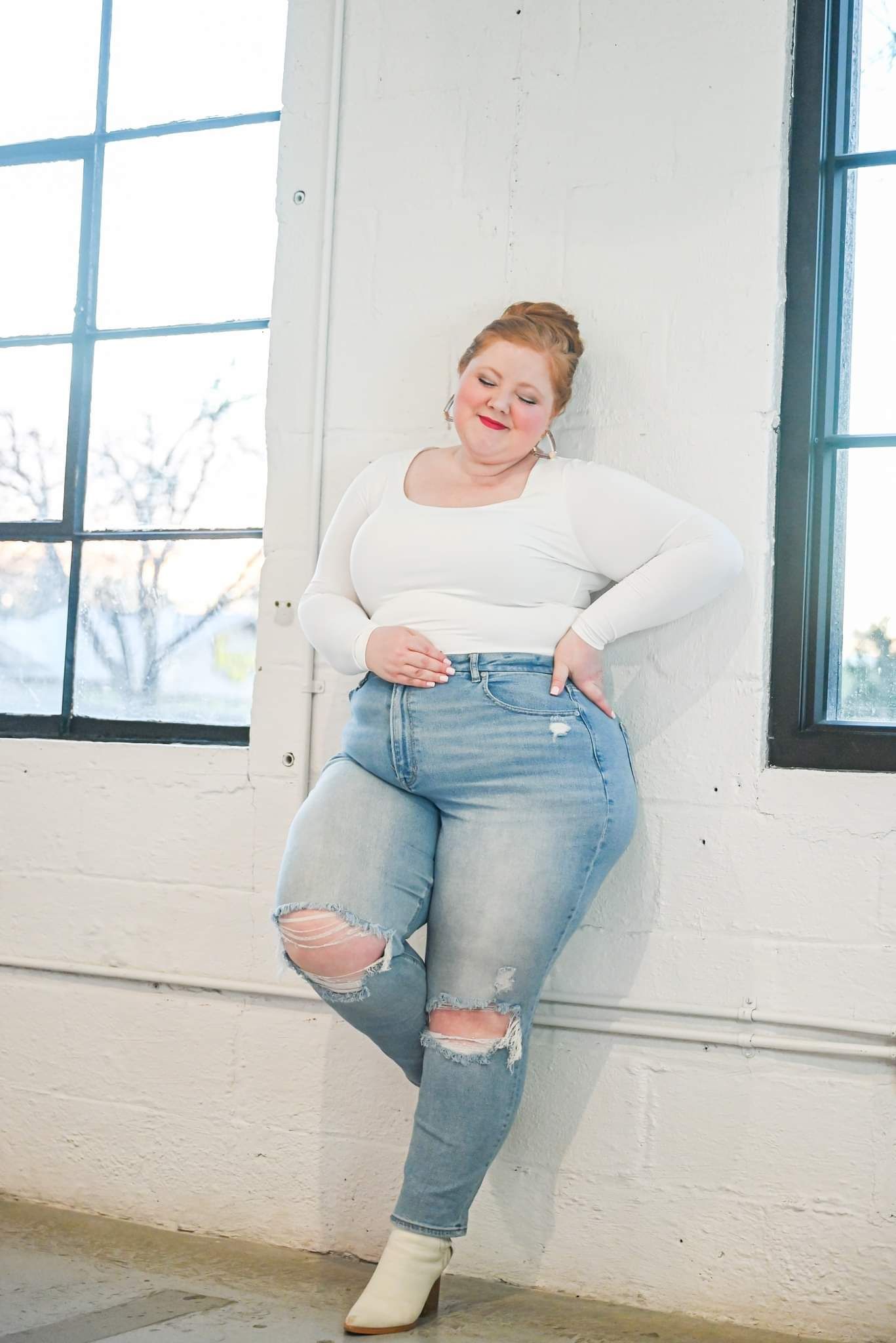 white long-sleeve square-neck top with light-wash distressed jeans