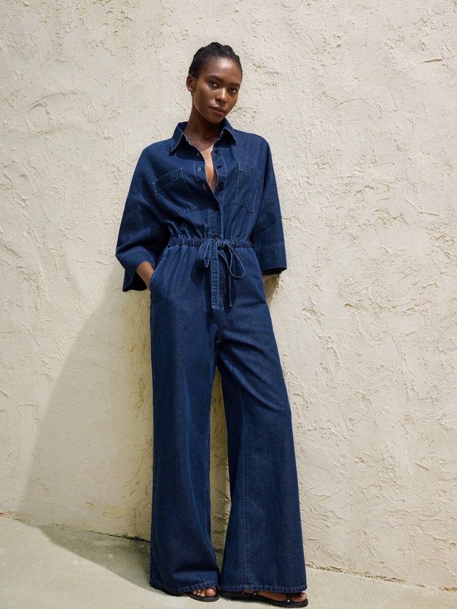 dark wash denim utility jumpsuit with drawstring waist