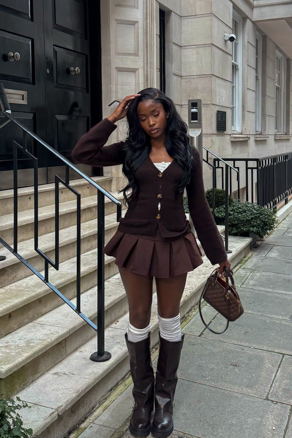 brown knit cardigan with matching pleated mini skirt and white camisole
