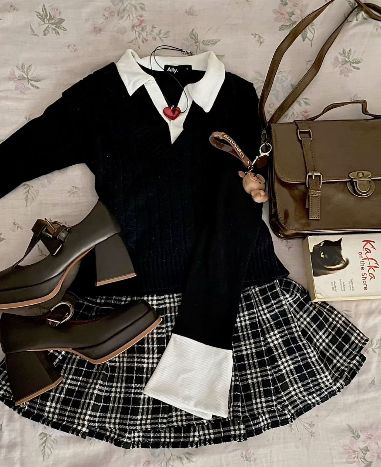 black knit polo sweater with white collar and plaid skirt